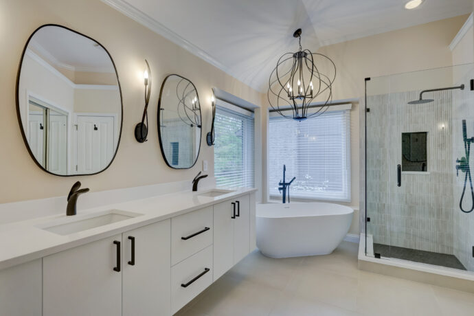 Luxury primary bathroom renovation with floating vanity and glass shower in West Bloomfield MI