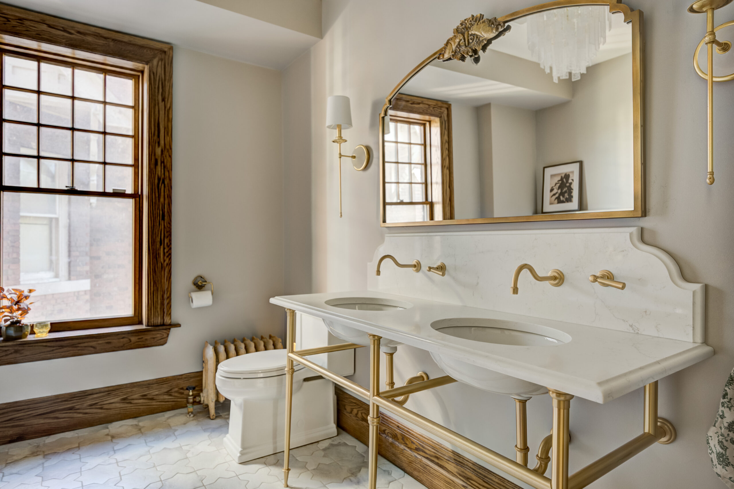 Luxury bathroom remodel with custom double vanity, brass fixtures, marble countertops, and timeless interior design by Maxwell Building Services