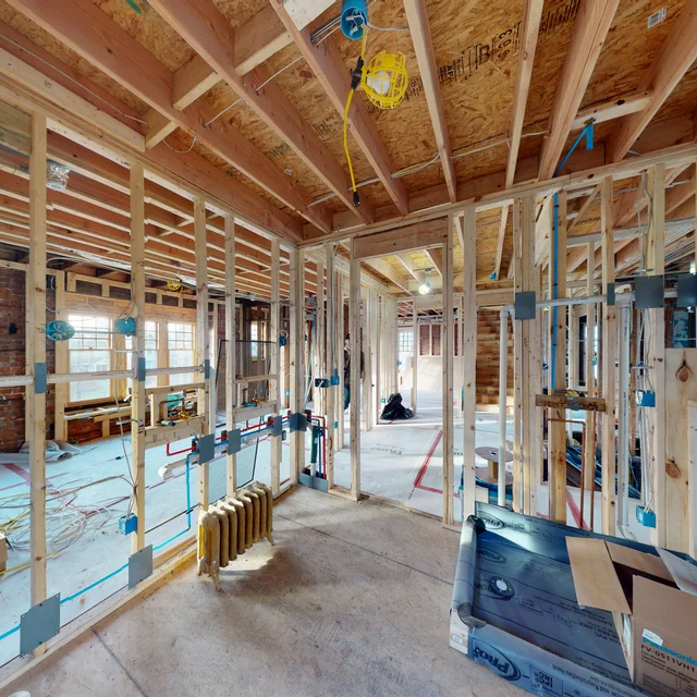 Down-to-the-studs whole-home renovation in Birmingham, Michigan, showing new framing, PEX plumbing and electrical rough-in before drywall, by Maxwell Building Services.