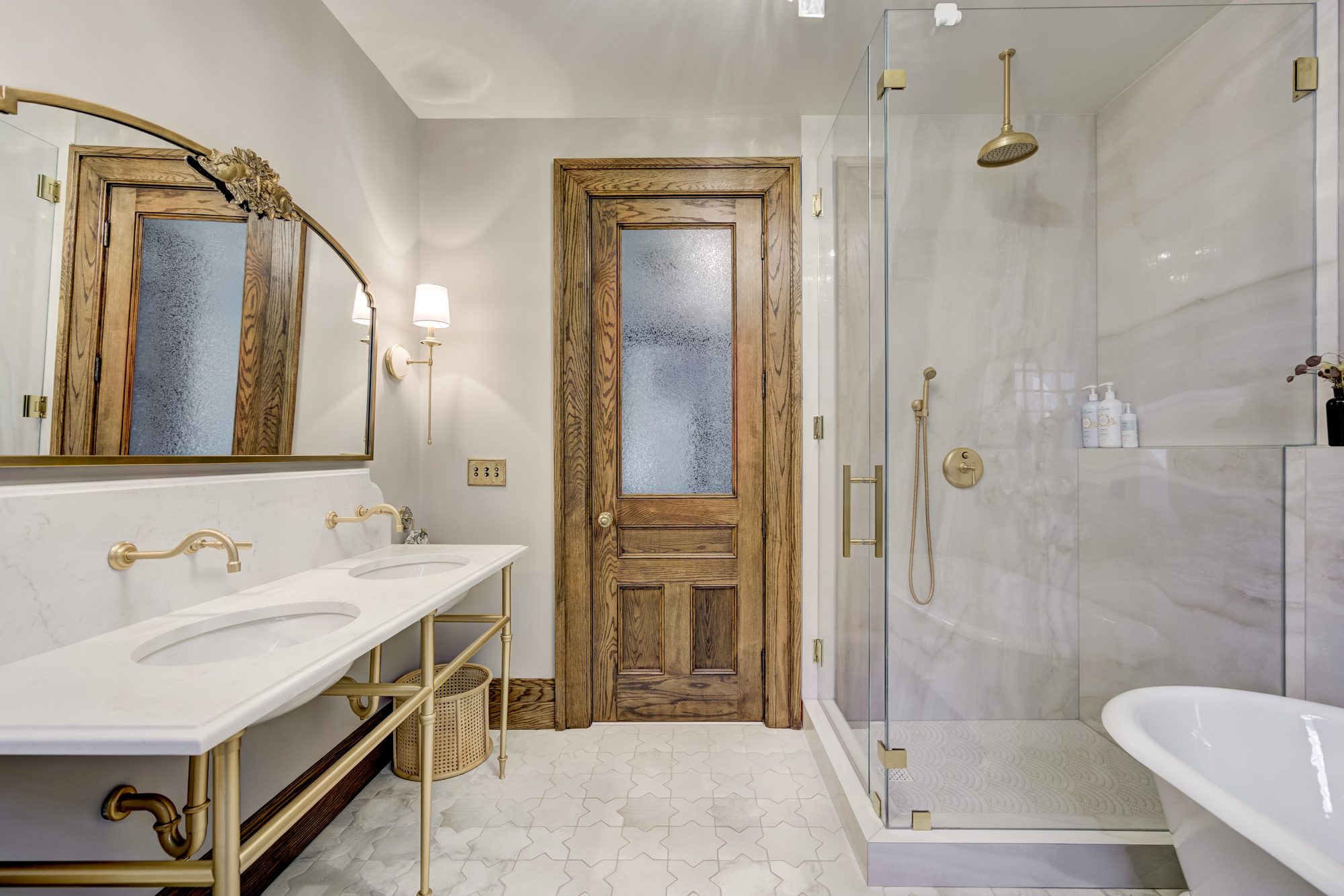 Double marble vanity looking toward the corner glass shower in a Birmingham MI bathroom remodel