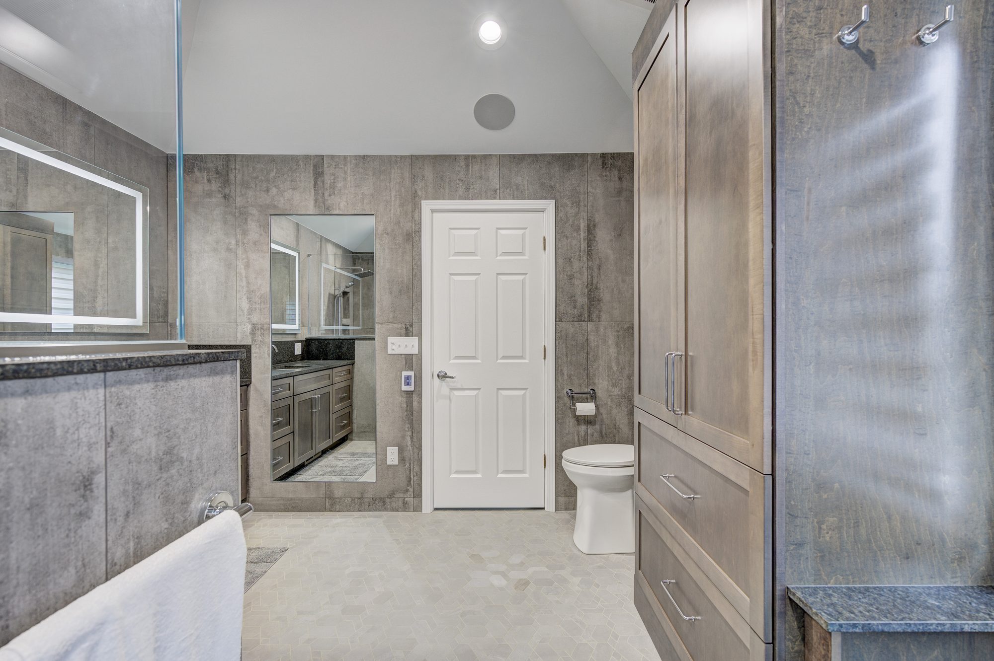 Vanity looking toward the built in linen tower in a Troy MI bathroom remodel