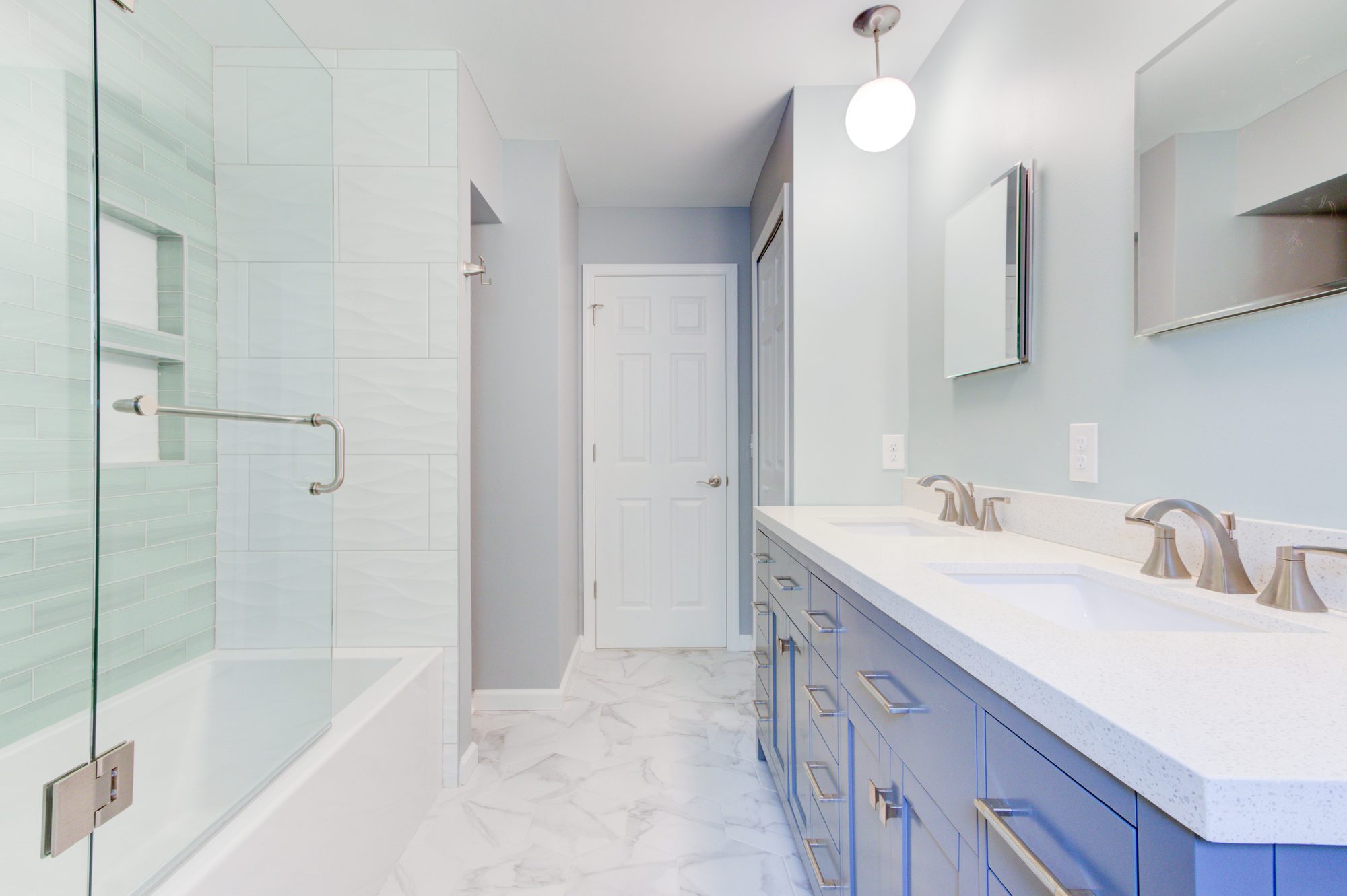 View from the tub toward the double vanity and built in linen shelves in a Troy MI bathroom remodel