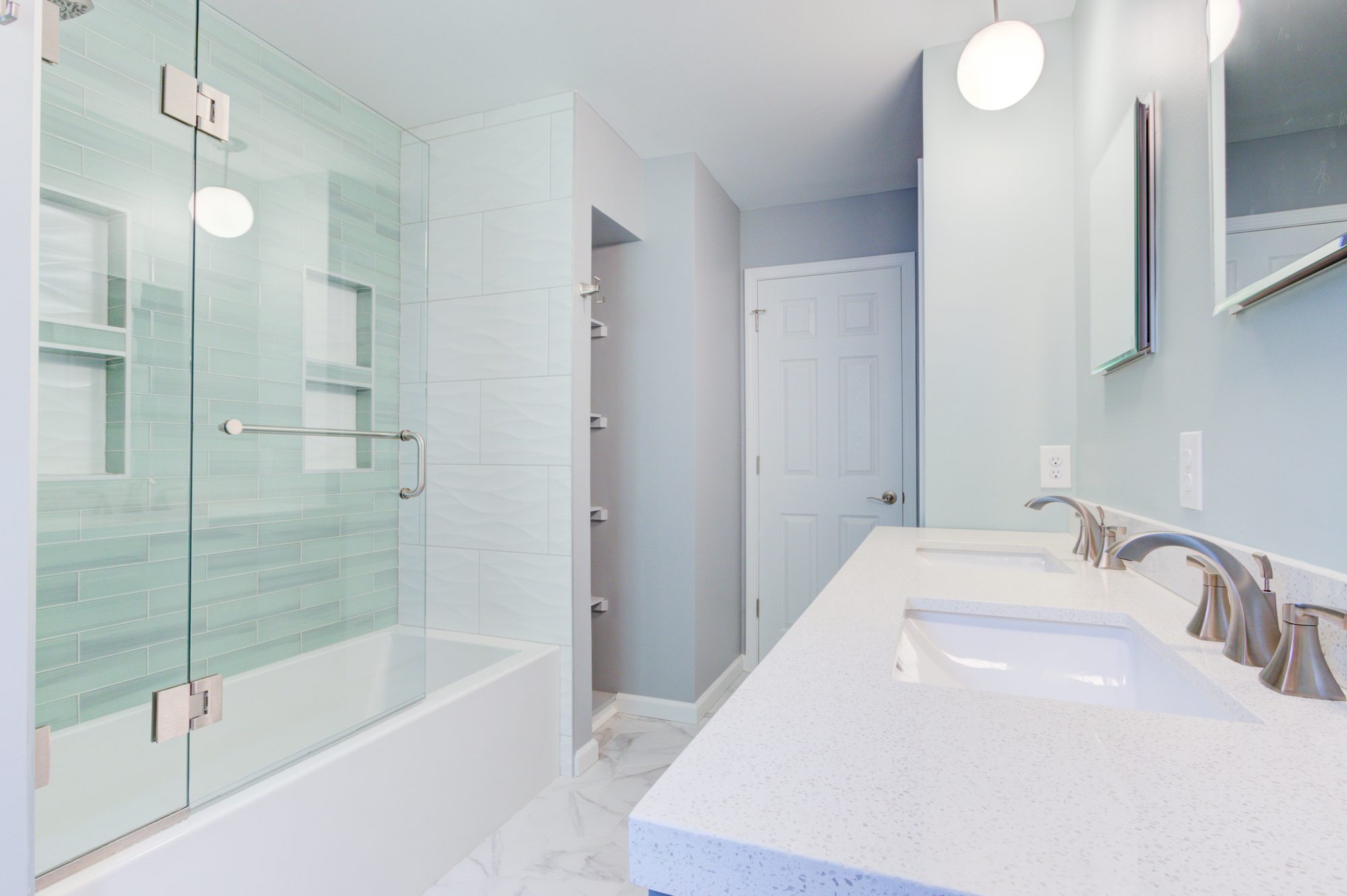 Vanity run looking toward recessed built in linen shelves in a Troy MI bathroom remodel