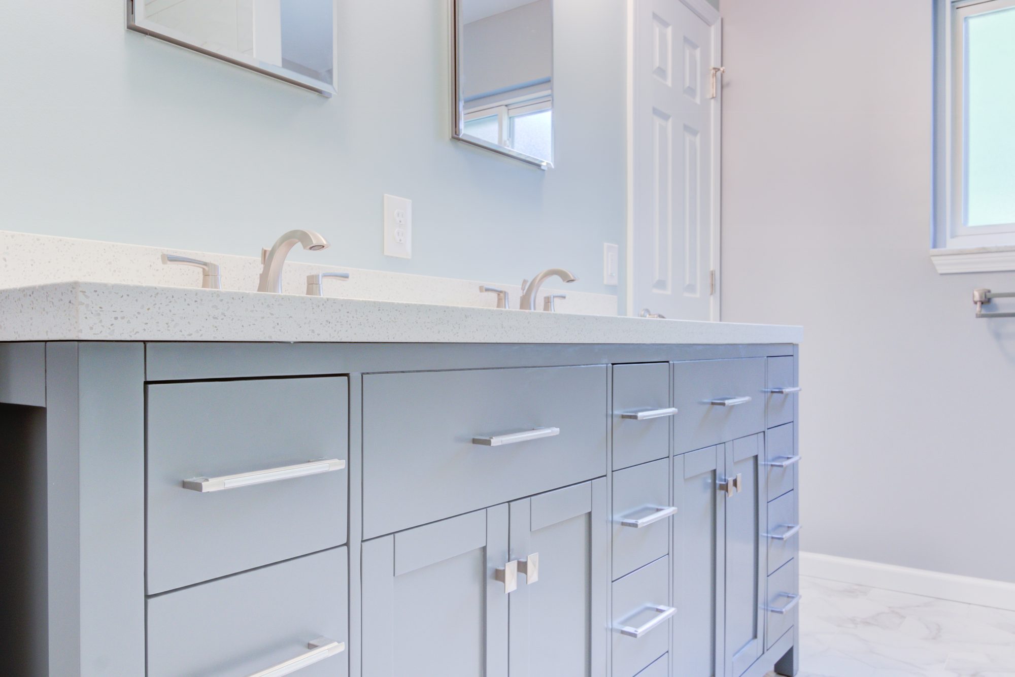 Double vanity with quartz counters, undermount sinks and brushed nickel faucets in a Troy MI bathroom