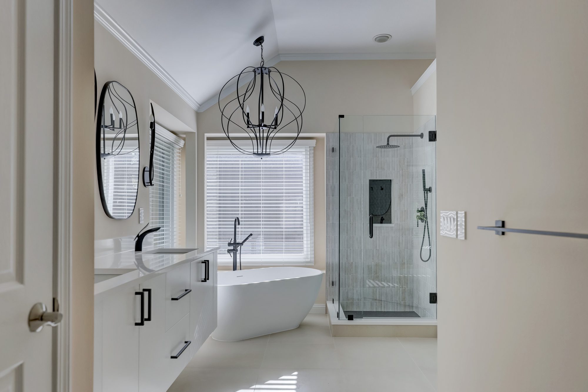 View from the doorway to the soaking tub and glass shower in a West Bloomfield MI bathroom remodel