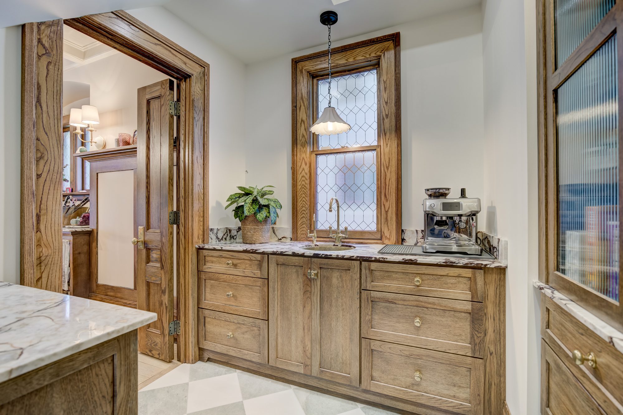 Coffee bar with a marble counter and custom oak cabinetry in a Birmingham MI butler pantry