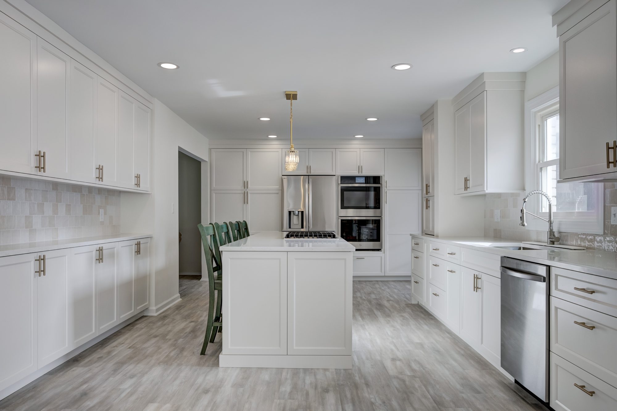 Remodeled Beverly Hills MI kitchen with a quartz island, glazed zellige backsplash and floor to ceiling cabinetry