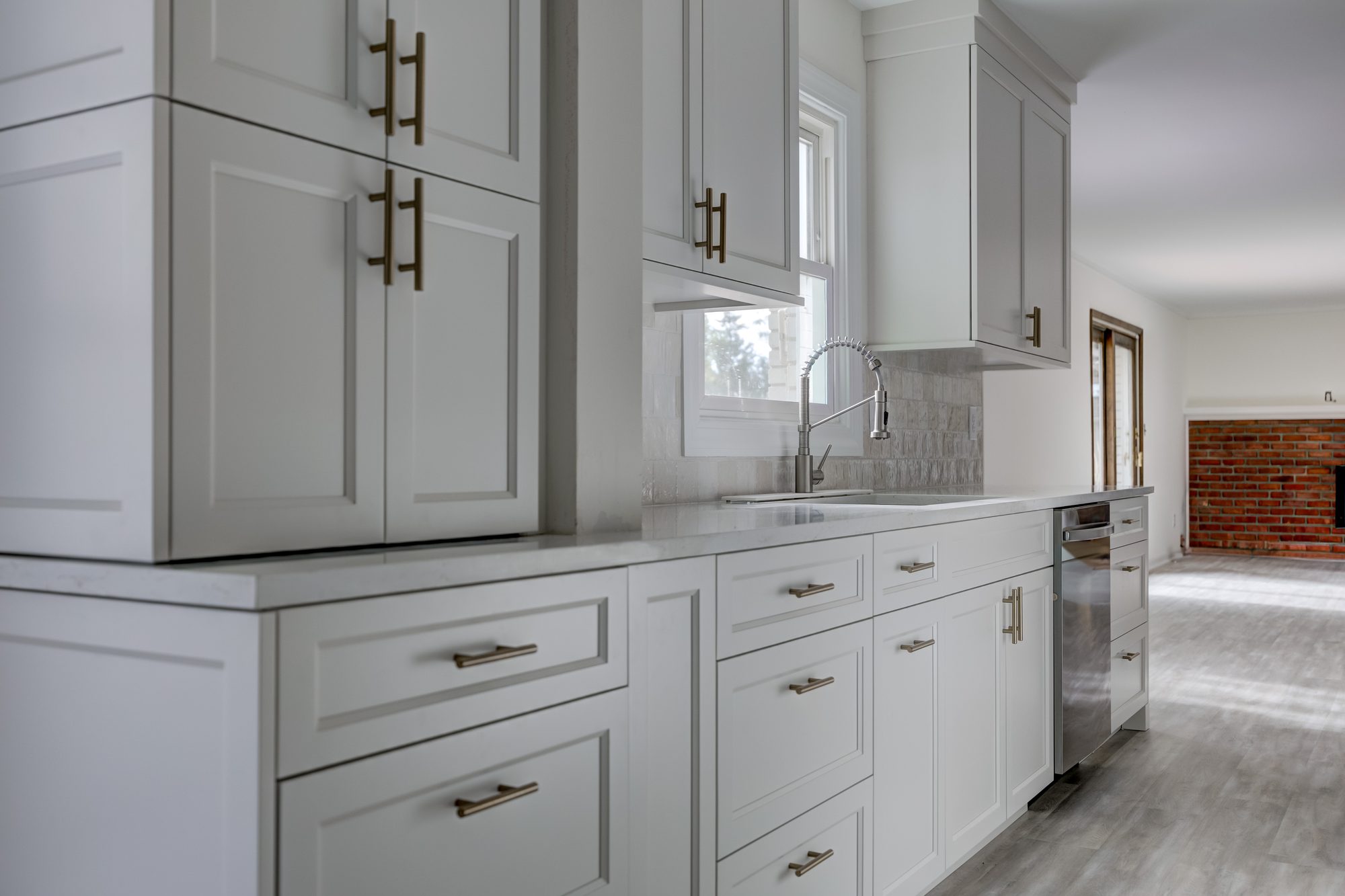 Undermount sink below the window with glazed zellige tile running the full wall in a Beverly Hills MI kitchen remodel