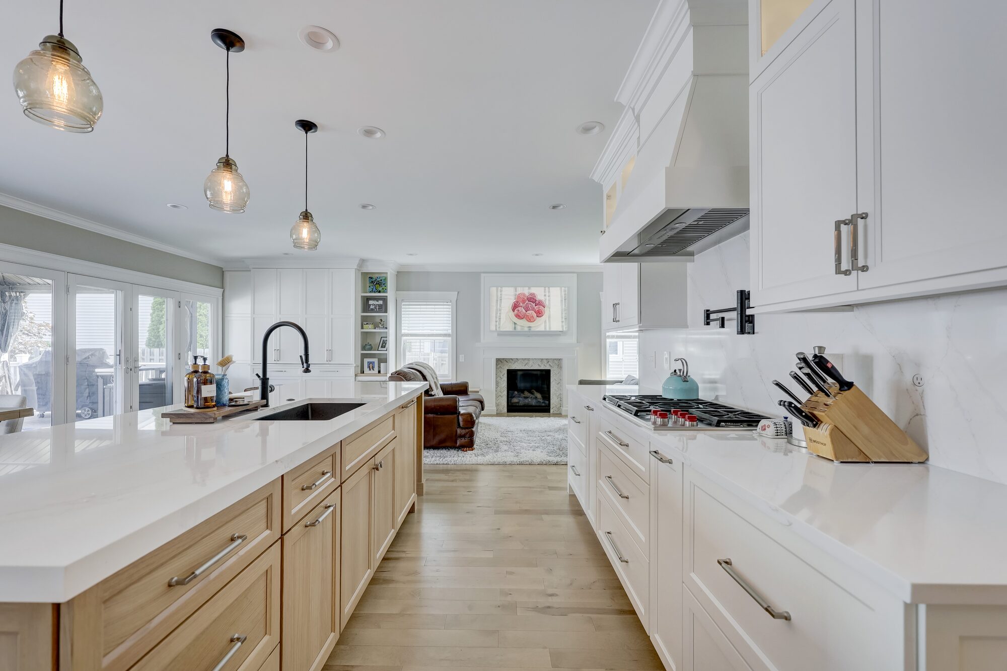 Kitchen island run looking toward the living room fireplace in a Birmingham MI first floor remodel