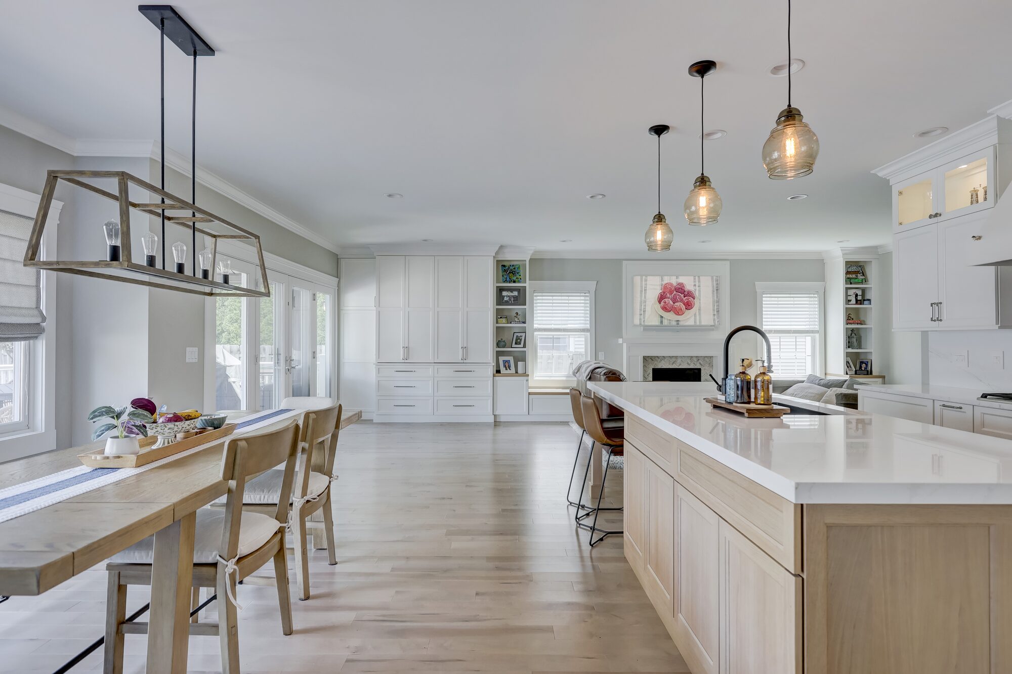 Dining table with a long view through the remodeled kitchen to the living room in Birmingham MI
