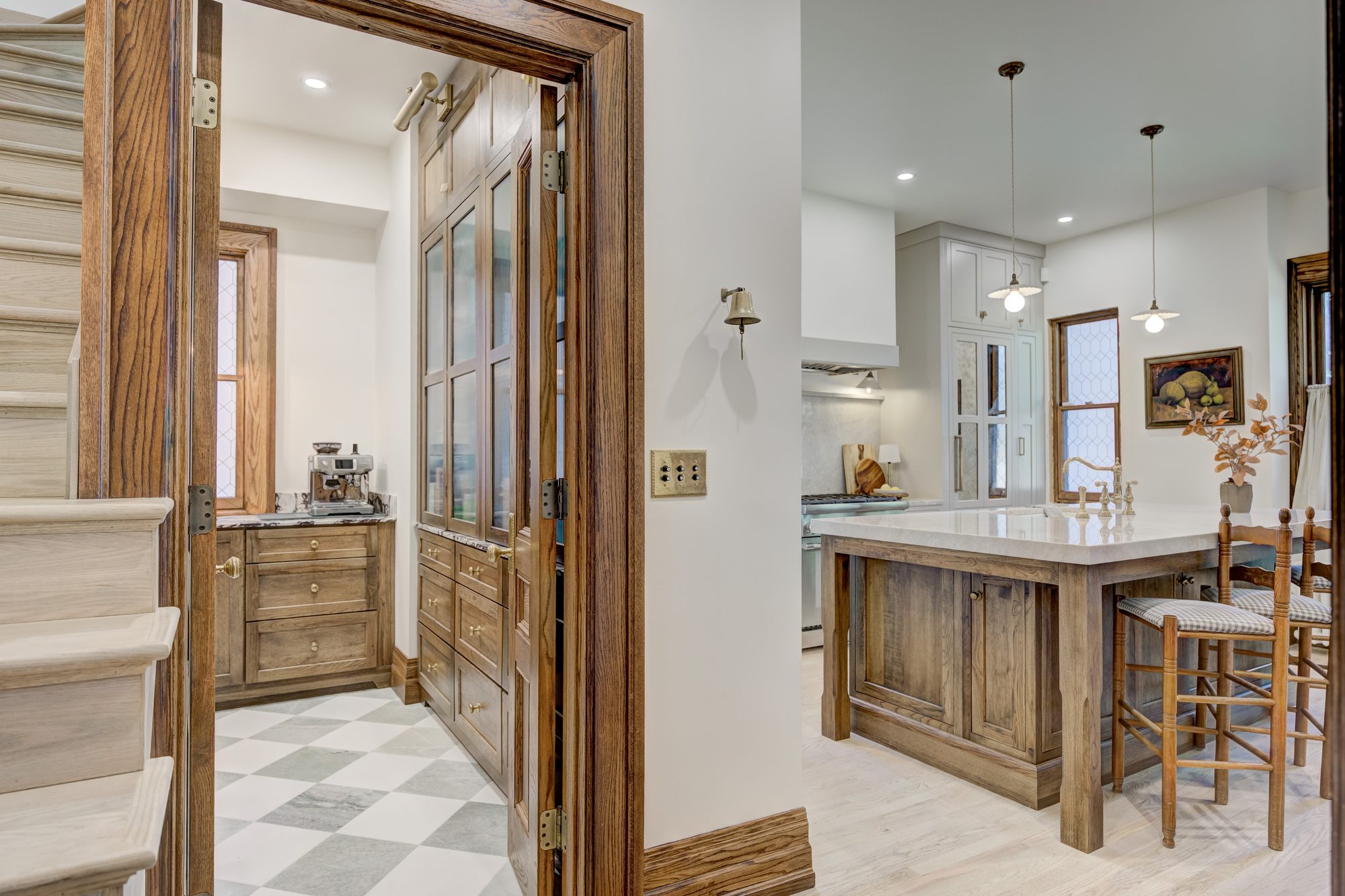 Butler pantry and coffee bar with checkerboard marble floor and reeded glass cabinets in a Birmingham MI remodel
