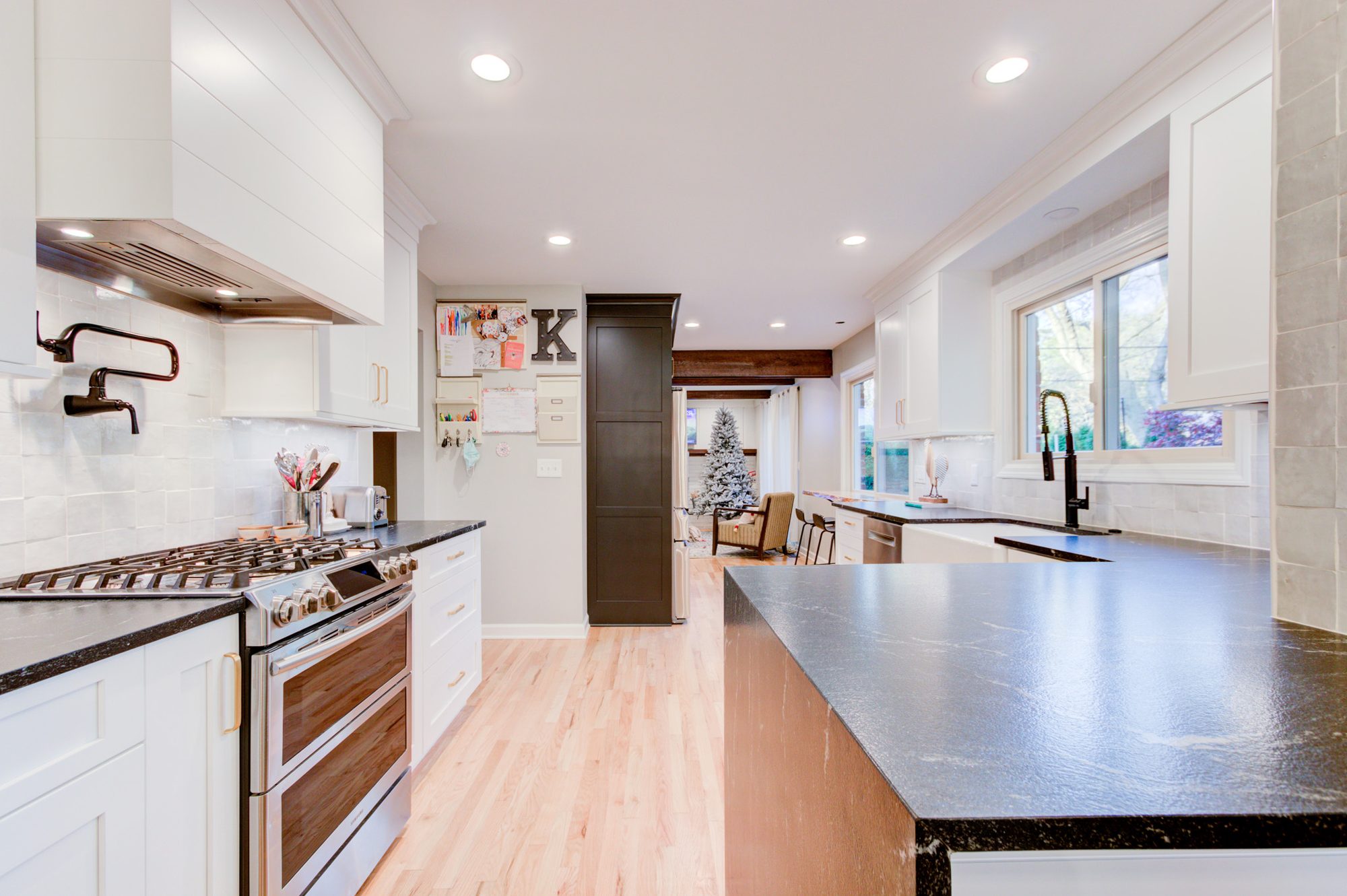 Range wall looking toward the granite peninsula and seating in a Bloomfield Hills MI kitchen remodel