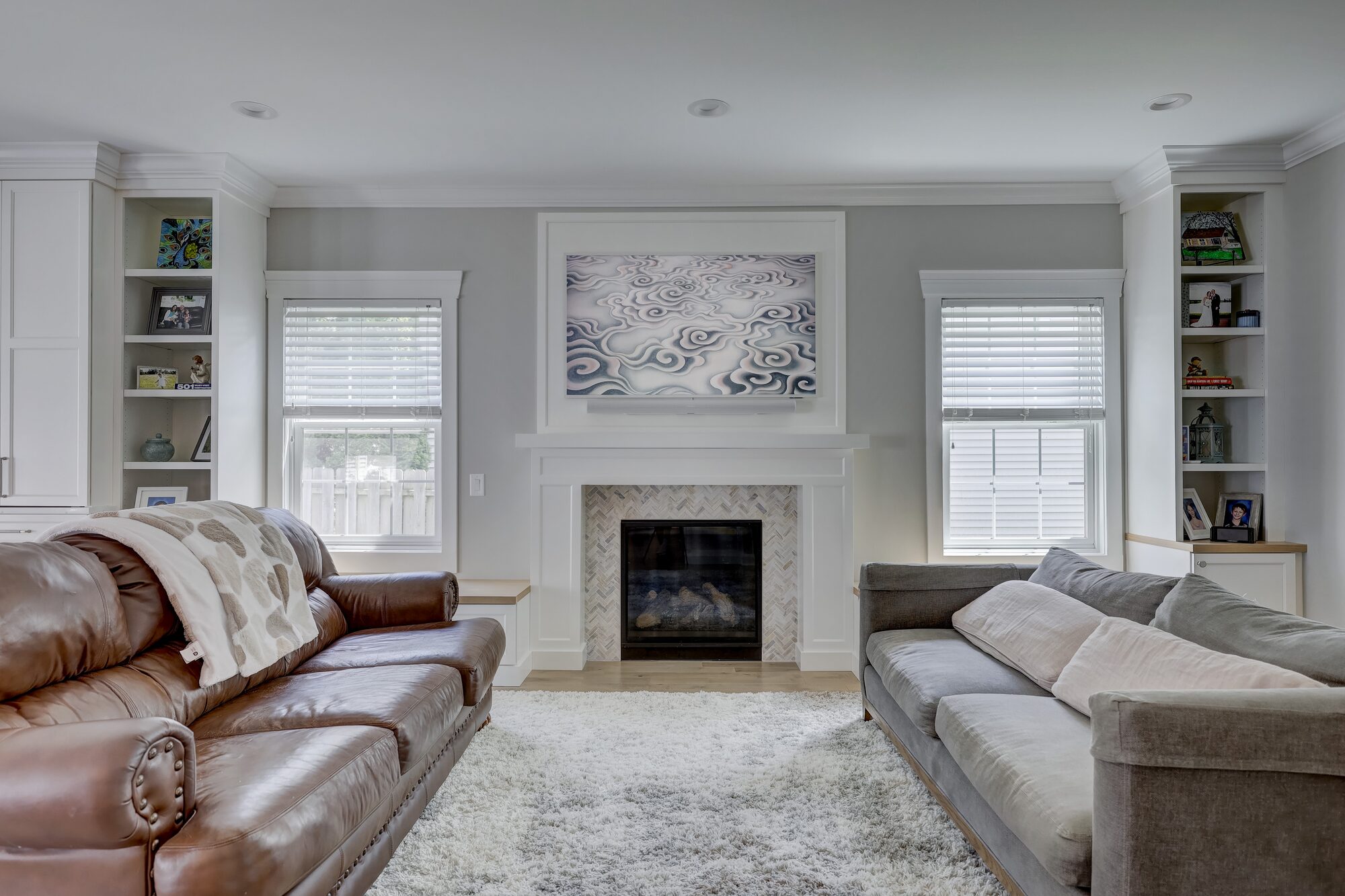 Herringbone tile fireplace surround with a painted mantel in a Birmingham MI living room remodel