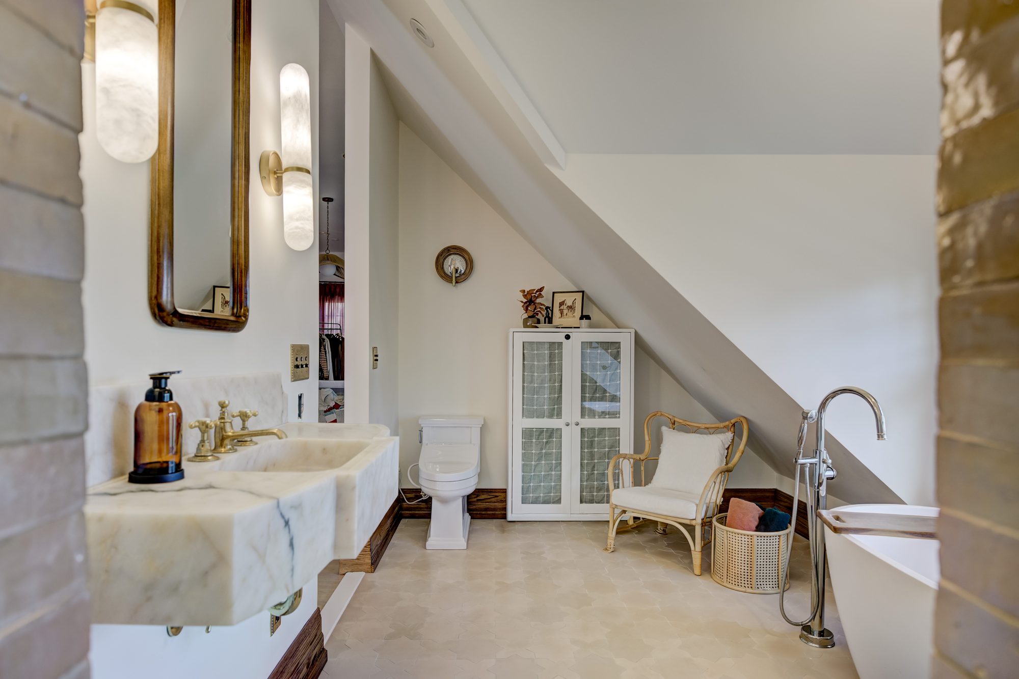 Antique marble sink looking toward the walk in closet in a Birmingham MI master bathroom remodel